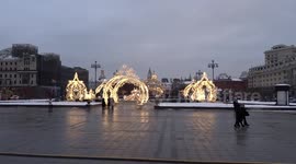 Moscow's Theatre Square with Christmas installations shining light on the snow