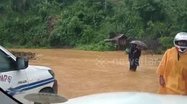 Residents wade through knee-deep floodwater as central Philippines hit by flooding