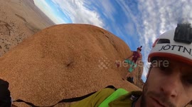 This mesmerizing footage shows a daring paraglider floating precariously over picturesque rolling sand dunes