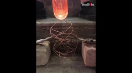 Hot Glass Blown Into Copper Cage To Create A Piece Of Glass Art