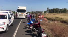 Truck flips over spilling thousands of cans of beer on the road