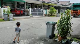 Two-year-old toddler excited to see garbage truck