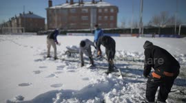 Rayo Majadahonda asks his supporter for help, hands and shovels to remove the snow from the football field in Madrid 13rd January, 2021.