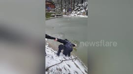 Chinese security guards form human chain to bring stray dog trapped in icy lake back to safety