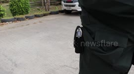 Thai police swap guns for sanitiser in their holsters to promote COVID-19 cleanliness