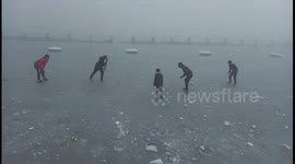 People play 'ice cricket' on top of frozen lake in north India