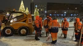 Brigade of snow shovelers ready to start clearing snow from a Moscow square