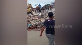 Rescue teams search rubble after strong earthquake hits Indonesia