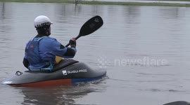 Kayakers take advantage as river bursts its banks in Derbyshire, UK