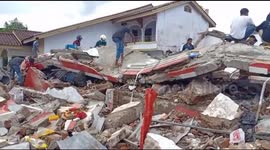 Residents pick through the debris of devastating Indonesian quake
