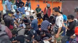Survivors of Indonesian quake try to salvage items from collapsed buildings