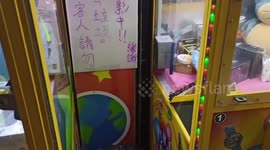 Cat Sleeps Inside Claw Grabbing Machine In Taiwan