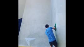 A climber finishes a coordination stye boulder