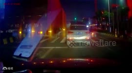 Car gets stuck underneath truck's trailer as it turns corner in southern China