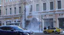 Snow shovelers clear snowdrifts off the roof of the famous Moscow Eliseyevsky store in freezing cold