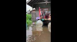 Police in Indonesia evacuate mother trapped in floods for several days