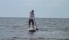 May Sunshine swimming and paddle boarding fun on the beach.