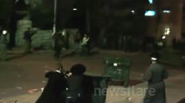 HUGE GARBAGE CAN THROWN AT POLICE