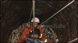 Boy rescued from a deep well in China