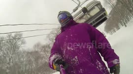 Snowboarder floored by chairlift while filming selfie