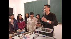 Physics teacher plays homemade instruments to demonstrate electromagnetism