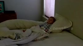Little girl pretends to snore like her dad