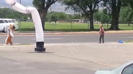 Man's dance battle with big dog mascot on roadside