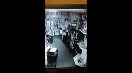 very slow motion of heavy lamp getting pushed off table by ghost in haunted antiques centre