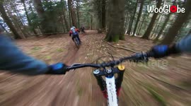 Watch these bikers weave in and out of trees as they descend down Swiss mountain trail
