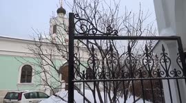 Parishioners leaving Russian church grounds with bottles of Holy Water on Orthodox Epiphany day