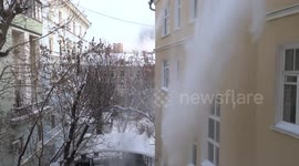 Roof snow cleaning in downtown Moscow in freezing cold