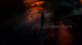 The incredible moment a troop of thrill seekers scale tallest chimney in Europe