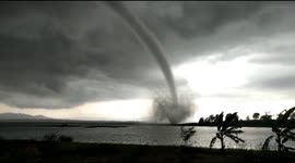 Gigantic waterspout forms over reservoir in central Indonesia