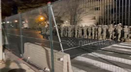 Members of the US National Guard stand in a large group on Independence Avenue outside of the Capitol