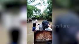 Residents use old fridge to float to safety during Philippines floods
