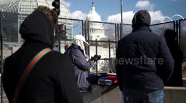 Public seen gathering outside the Capitol Mall barricades on Joe Biden's inauguration