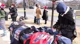 Inauguration Day marked flags, street performances, protest signs, and police in riot gear