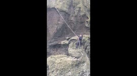 Icelander swing on rope to view Puffins