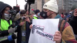 Moscow protester surrounded by reporters demands release of Alexei Navalny
