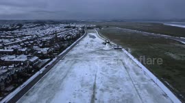 Stunning drone footage of rare snow-covered shoreline on the English coast