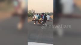 Skilful rider carries FIVE passengers on his motorbike