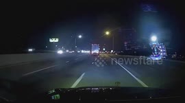 Drifting Car Nudges A Truck And Crashes Onto Concrete Barrier