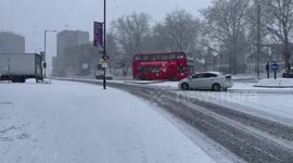 Cars and buses struggling to drive in London snow