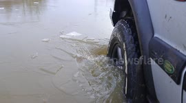 4x4 breaks the ice on a frozen flooded road in Yorkshire