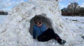 Children play in the snow day after heavy snow brought UK to a stand still