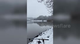 Angler watches as Kingfisher catches fish then uses rod as perch to eat it