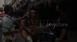 Taxi driver made homeless during pandemic now busks with a pet monkey on his shoulder