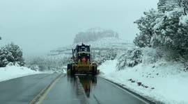 Plows work to clear roads after a winter storm in Sedona, Arizona