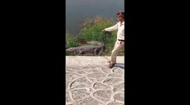Alleged drunk man gets dangerously close to crocodile in western India
