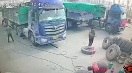 Tyre explodes while being inflated, almost knocking Chinese worker off his feet